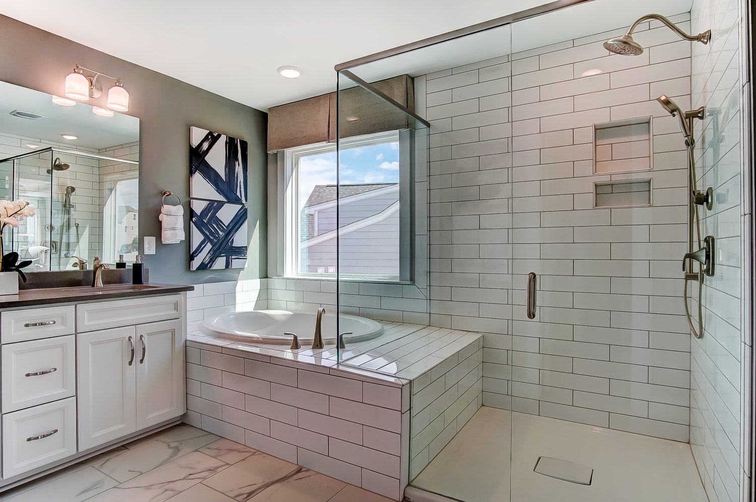 luxury walk in shower and tub with white tile